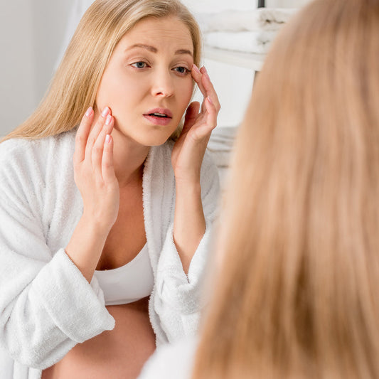 Pregnant woman caring gently for skin prone to acne